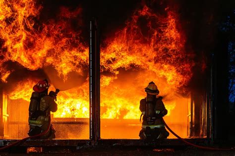 vigili del fuoco che spengono un incendio su un veicolo fermo a bordo strada