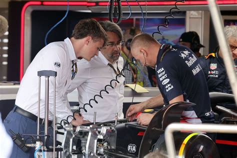 FIA officials inspecting F1 car