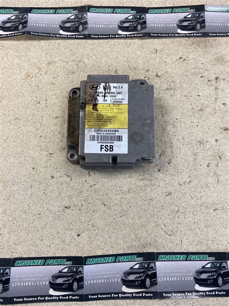 Detailed image of a Hyundai ix35 airbag control unit with part number visible