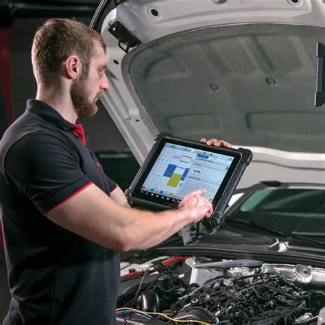 Mechanic performing a diagnostic scan on an Opel Mokka