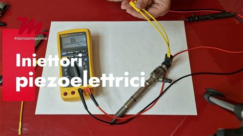 Tecnico che esegue test elettrici su un iniettore con un multimetro