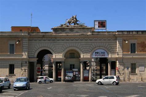 Veduta esterna del Mattatoio di Roma al tramonto, con giochi di luce sulle facciate.
