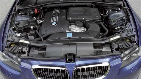 Internal view of a BMW 320d E90 engine compartment with the engine control unit clearly visible