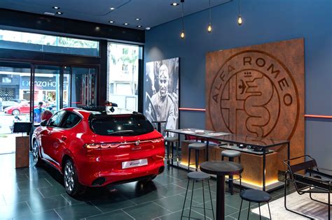 Alfa Romeo logo and showroom interior
