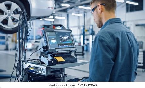 Car workshop with technician performing diagnostic