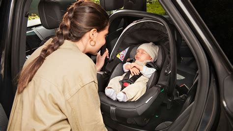 Genitori che allacciano il bambino in auto