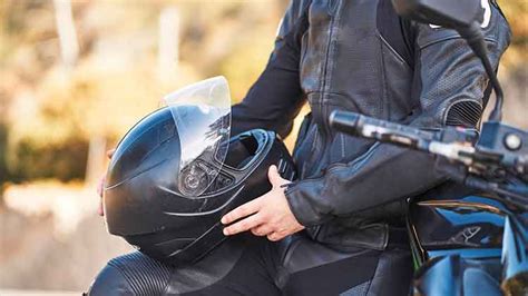 Motociclista con casco e interfono in azione