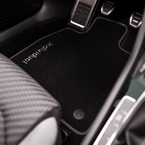Interno di una Toyota iQ con tappetini personalizzati e organizer per il bagagliaio