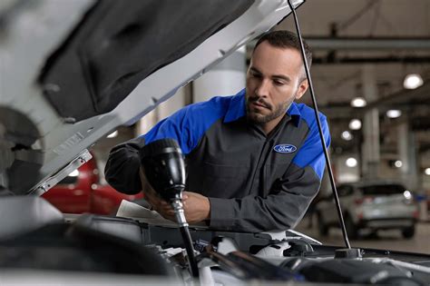 Ford service technician working on a car