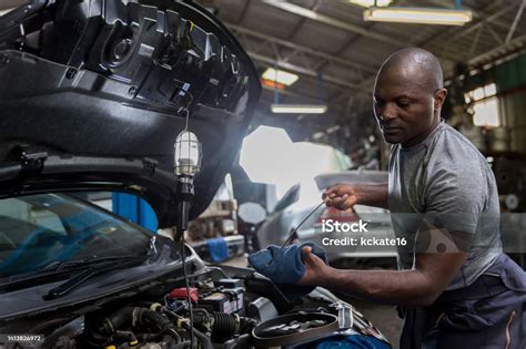 Mechanic checking a car transmission