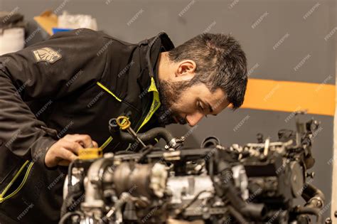 Car mechanic inspecting a car engine