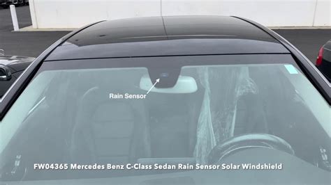 Close-up of a windshield with a rain sensor module visible