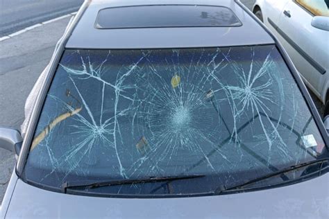 Image of a damaged windshield on a car, highlighting the need for careful inspection upon delivery