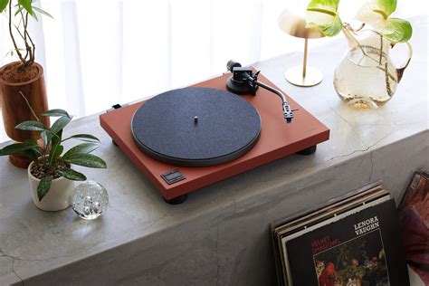 Immagine di un giradischi vintage accanto a un moderno streamer audio digitale