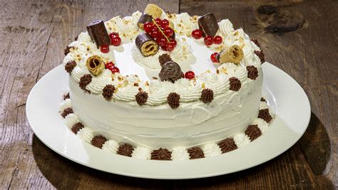 Immagine di una torta Moka decorata con ciuffi di crema e scaglie di cioccolato