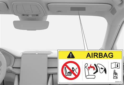 Front passenger sun visor with airbag warning label