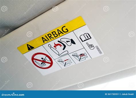 Close-up of an airbag warning label on a sun visor
