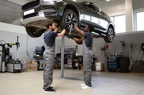 High-tech garage with technicians working on vehicles