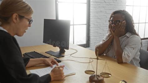 Lawyer discussing case with client in office