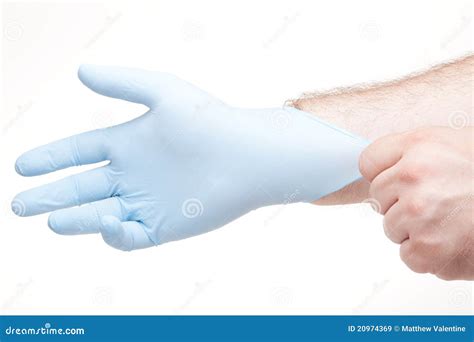 Immagine di una mano che indossa un guanto e tiene una lampadina del faro