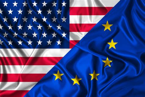 Bandiere di USA e UE con un'auto al centro