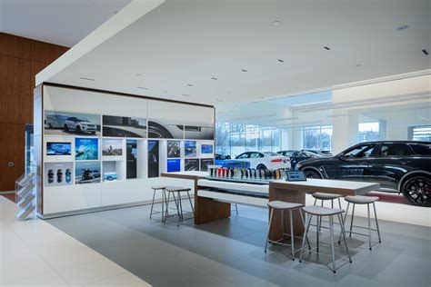 Modern car dealership interior with sales staff