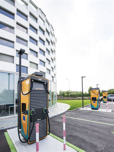 Stazione di servizio futuristica con punti di ricarica elettrica e servizi aggiuntivi