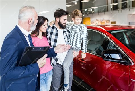 Happy family in a car showroom